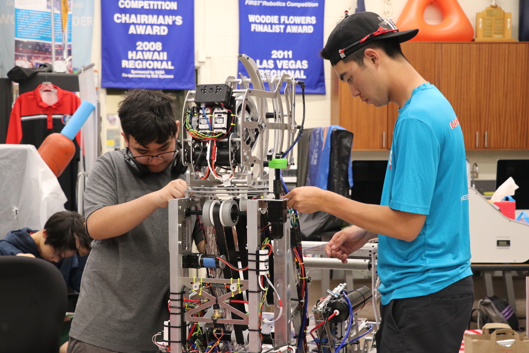 Anthony and Micah fixing wires on the robot